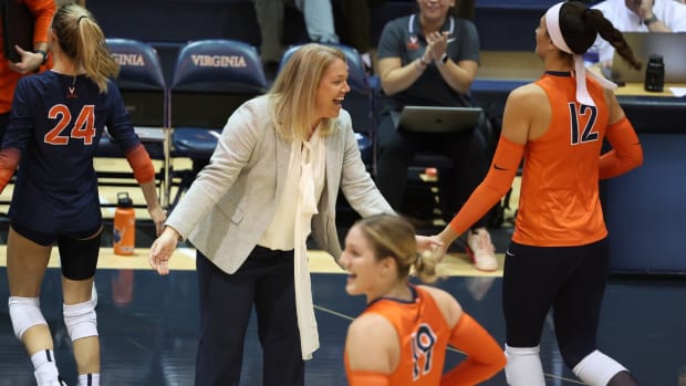 Head coach Shannon Wells congratulates her team during the Virginia volleyball match against Pittsburgh at Memorial Gymnasium.